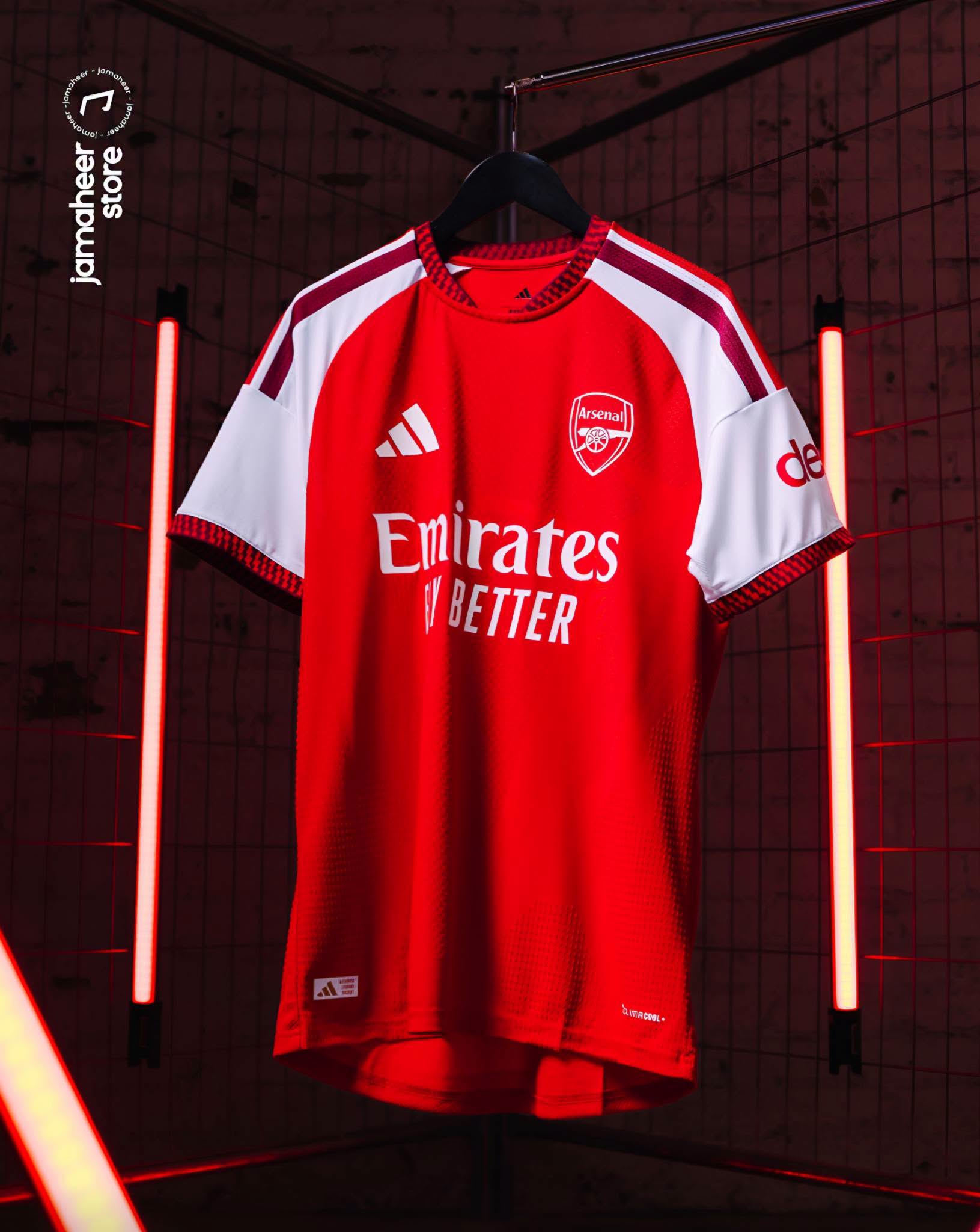 Arsenal home shirt hanging between red neon tubes